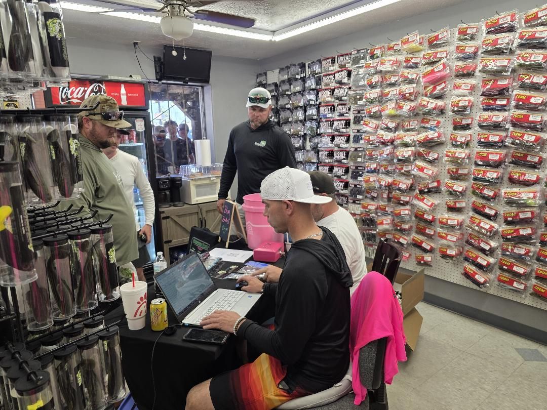 Anglers registering at a table inside the bait shop