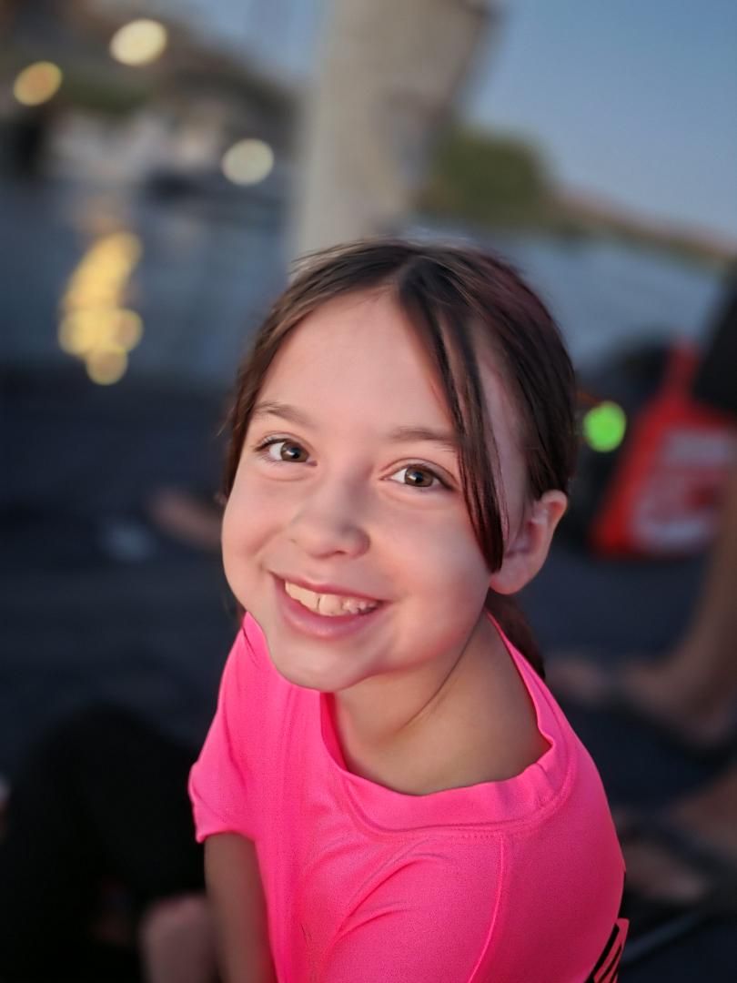 A young fan in a pink Skinner Baits shirt smiling