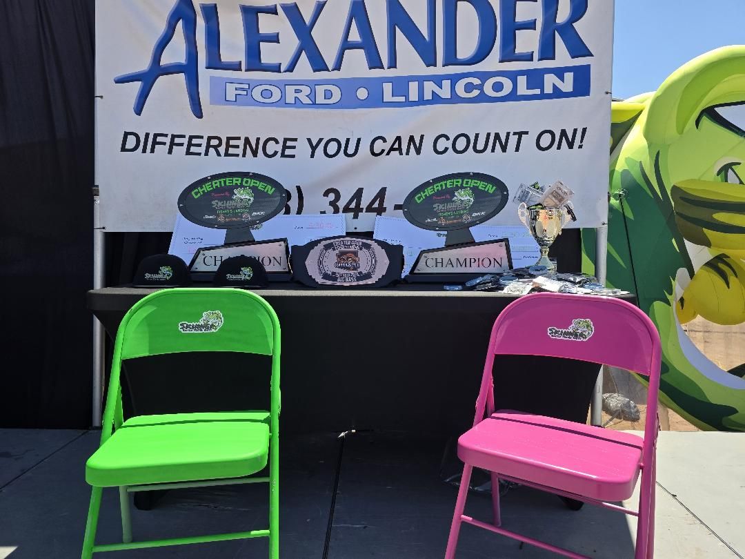 The awards table with champion plaques and green and pink chairs