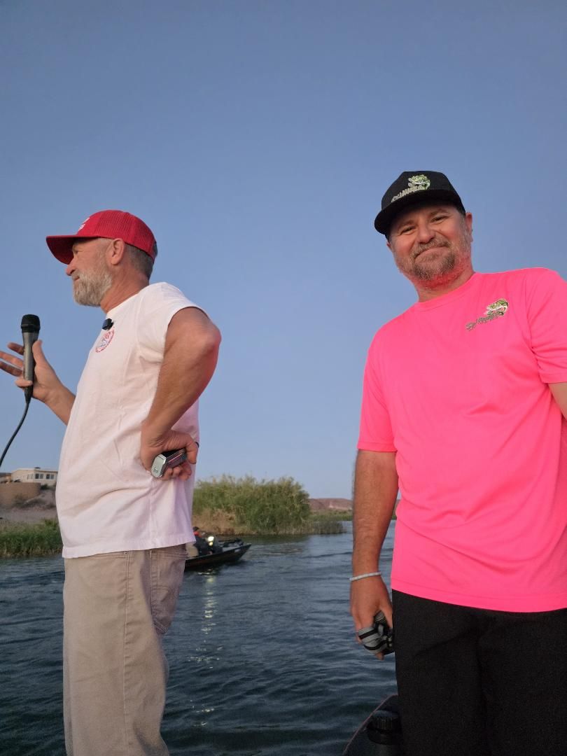 An announcer with a microphone and Billy in a pink shirt at the launch