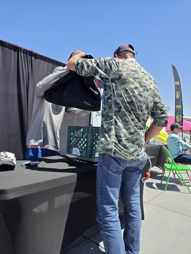 An angler bagging fish at the weigh scale